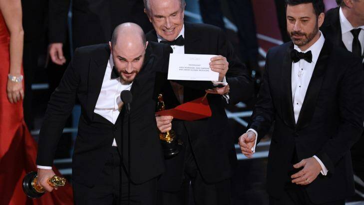 Jordan Horowitz, producer of "La La Land," shows the envelope revealing "Moonlight" as the true winner of best picture at the Oscars on Sunday, Feb. 26, 2017, at the Dolby Theatre in Los Angeles. Presenter Warren Beatty and host Jimmy Kimmel look on from right. (Photo by Chris Pizzello/Invision/AP) Photo: CHRIS PIZZELLO