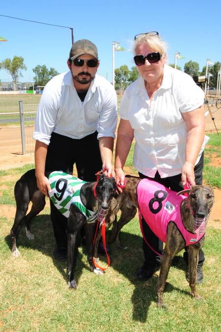 Greg and Deb Ford with their greyhounds, which ran one-two in the opening event at Dawson Park yesterday.