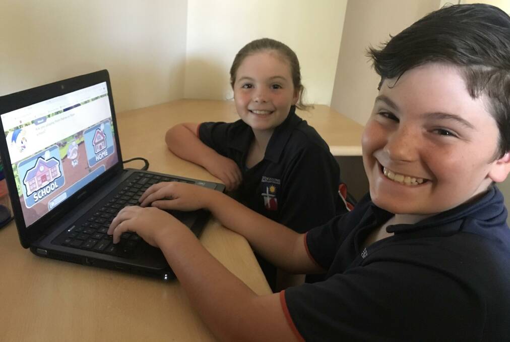 CONNECTED LEARNING: Students Grace and Henry Ball utilise a mobile connection to access an online tutorial site. 5G technology promises to increase access to remote learning, enabling virtual reality and 4K streaming. 