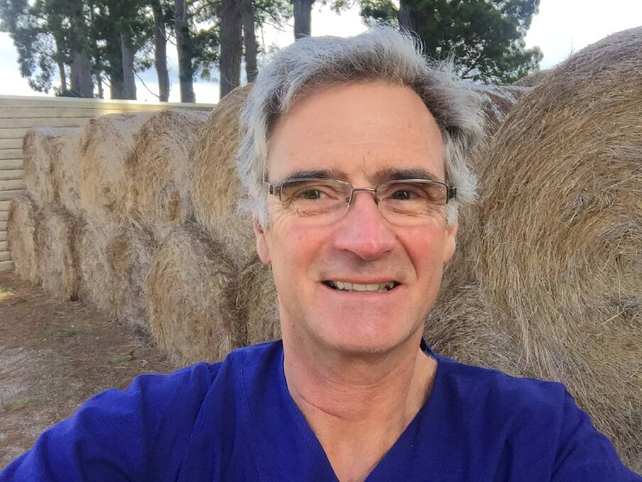 HELPING OUT: Dr Peter Brown with the round bales of hay he is offering to Central West farmers if he can get it transported from his Victorian farm. Photos: Supplied