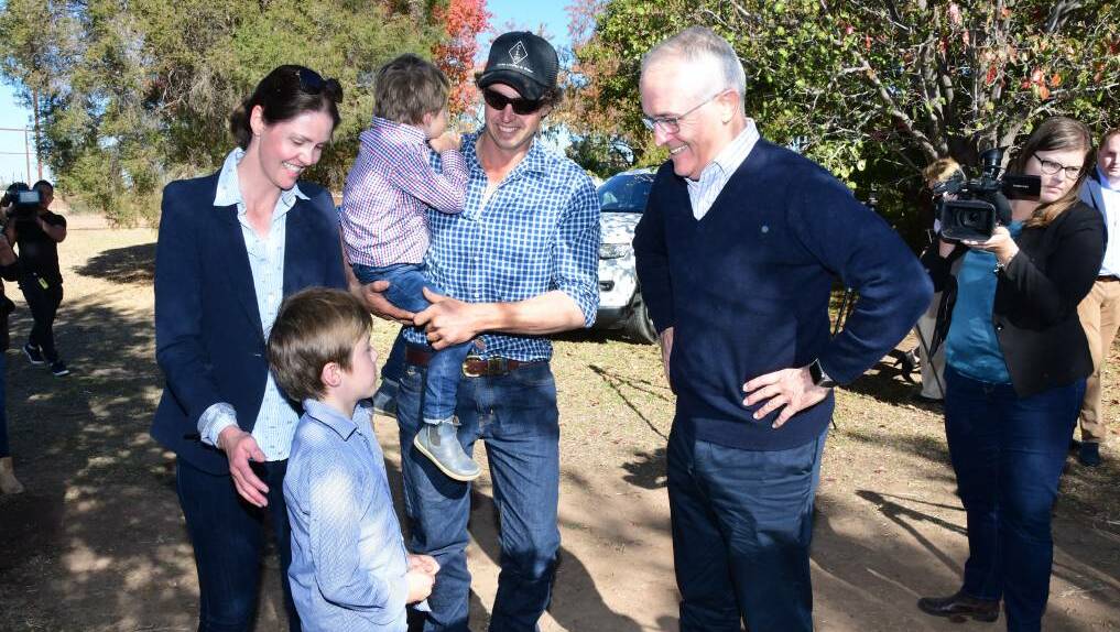 RELIEF: Farmers Ashlea and Phil Miles with children Harry and Jack greeting Malcolm Turnbull in Trangie on Monday. Click the image for more. Photo: BELINDA SOOLE