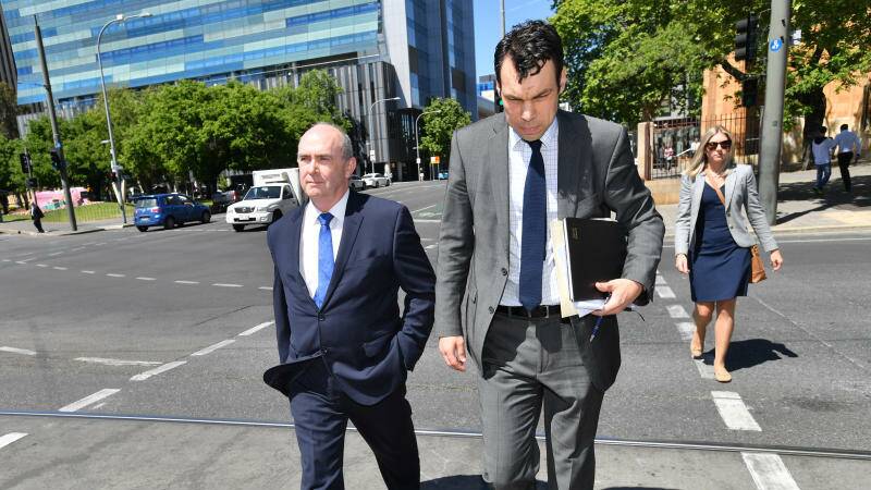 Former artistic director of the South Australian state opera Timothy Sexton (left) is seen outside the Adelaide Magistrates Court.
