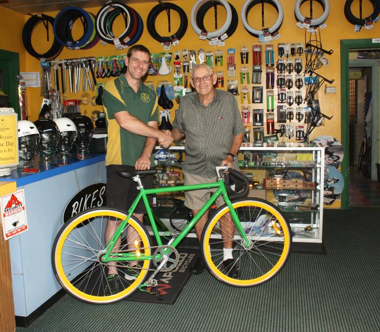 Thank you: The Bike Shoppe’s Michael Milsom presents the donated bike to Narromine Cycle Club volunteer Doug Horder. Photo: Taylor Jurd. 