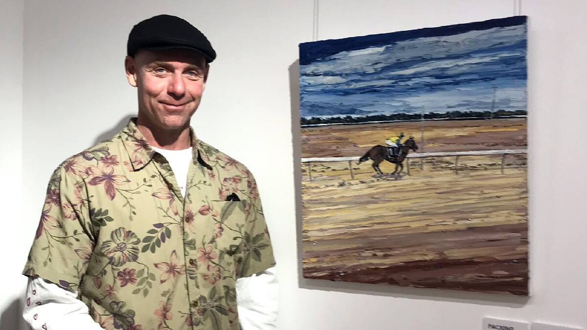 Artist Chris Kunko with his artwork, Trotting Over Kangaroo Ribs, which was exhibited in the 2019 Outback Archies, Packing Room Prize. Photo: Supplied. 
