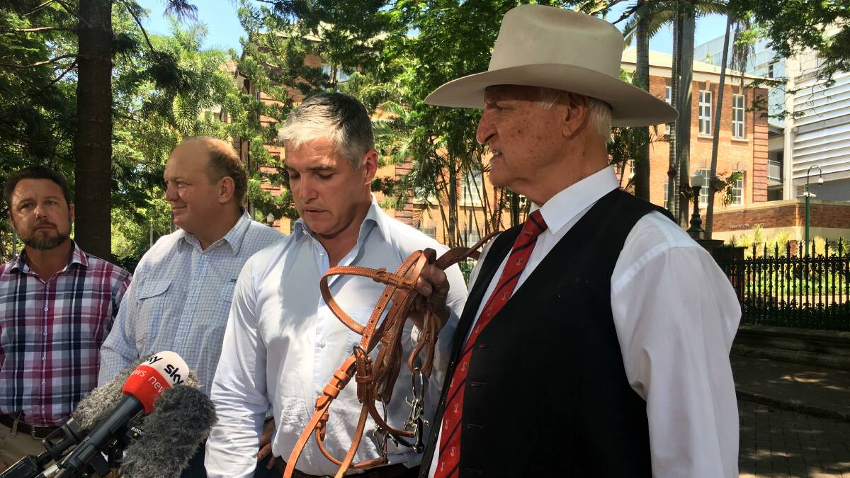 TWO BOB: Bob Katter gives reins to son Robbie in Brisbane on Monday while state KAP MPs Nick Dametto and Shane Knuth look on. Photo: supplied.