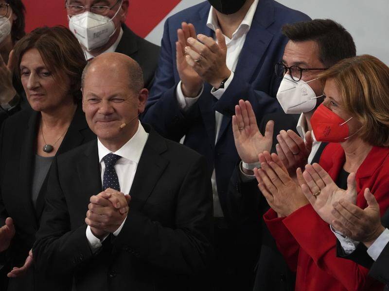 The Social Democrats of Olaf Scholz (c) have won 25.9 per cent of vote in Germany's election.