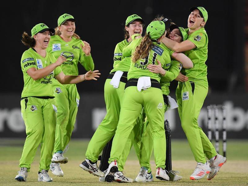 Sydney Thunder players celebrate the final wicket of their WBBL semi-final win over Brisbane Heat.