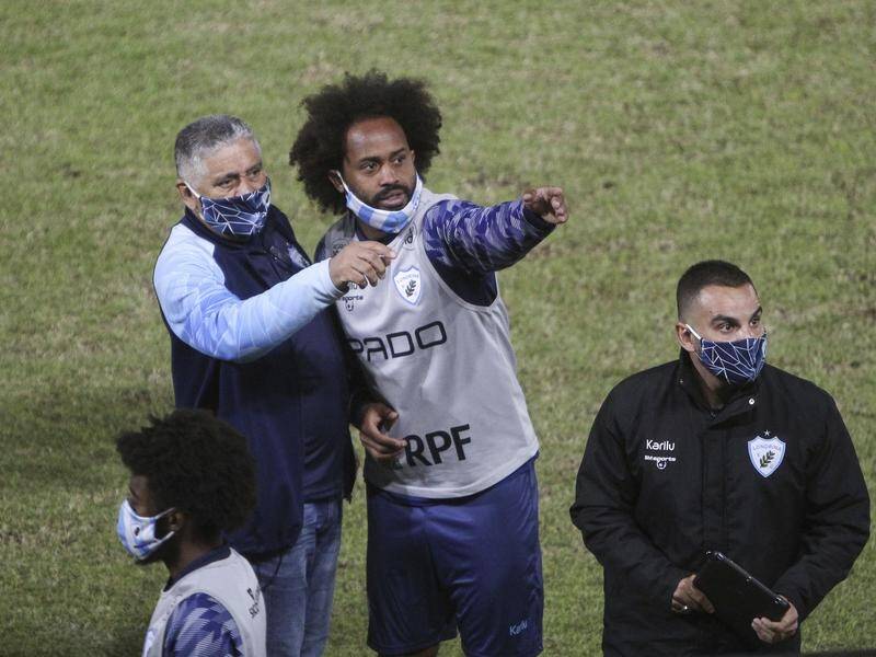 Celsinho points to the director's box after being racially abused at a soccer match in Brazil.