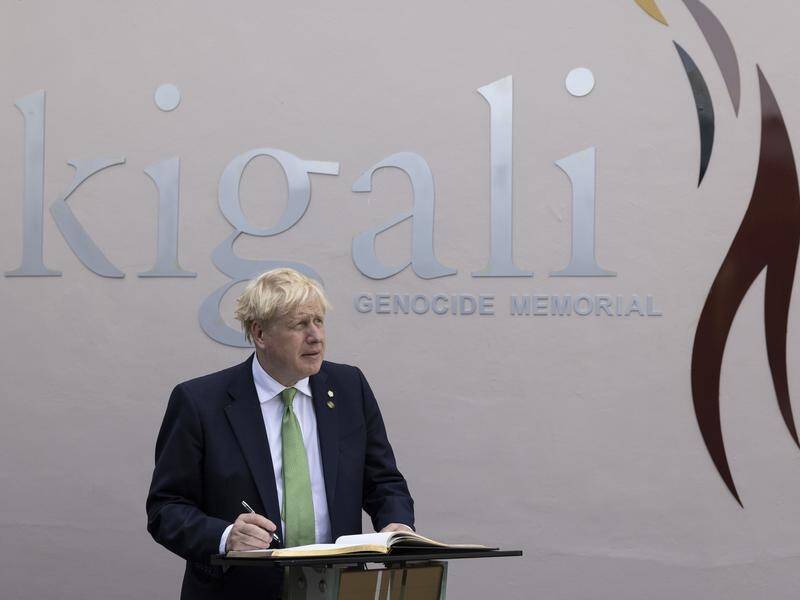 British PM Boris Johnson signs the visitors book at the Kigali Genocide Memorial in Rwanda.