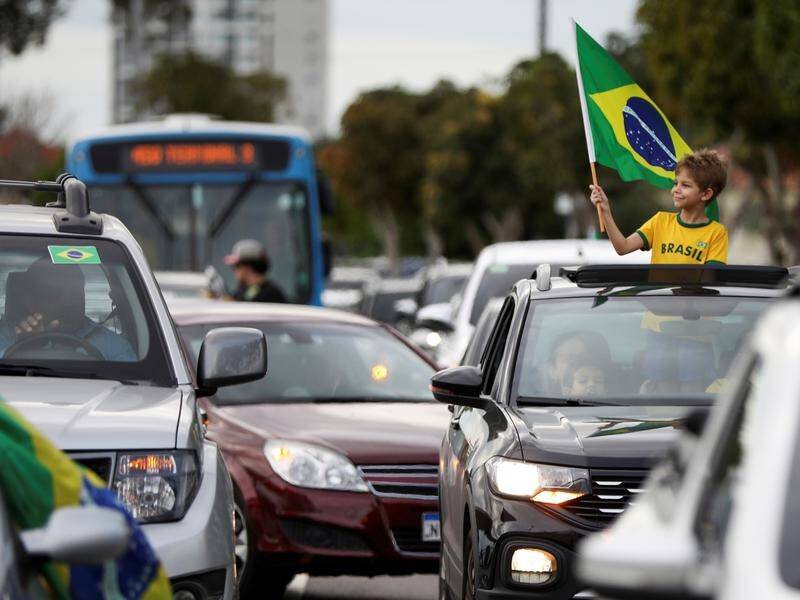 President Bolsonaro's slogan 'Brazil cannot stop' has angered governors trying to fight coronavirus.