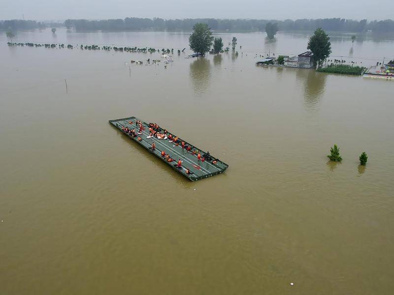 A motorised raft bridge was used to rescue residents of a flooded area in China's Henan Province.