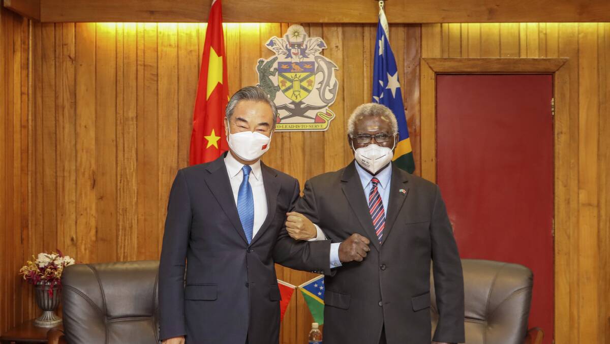 Solomon Islands Prime Minister Manasseh Sogavare (right) locks arms with visiting Chinese Foreign Minister Wang Yi in Honiara on Thursday. Picture: Xinhua News Agency via AP