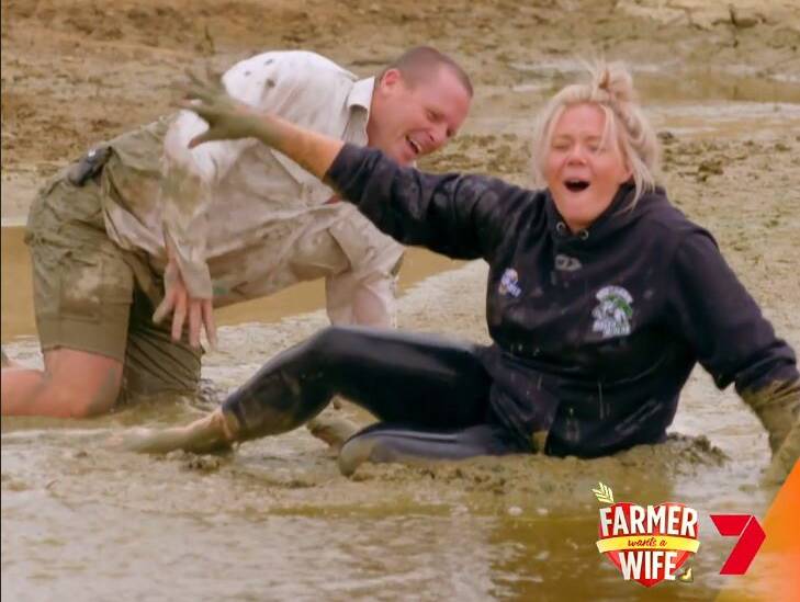 FUN AND GAMES: Crookwell farmer Neil Seaman and Bathurst Karissa Godfrey during a mud fight on his farm. Photo: SEVEN